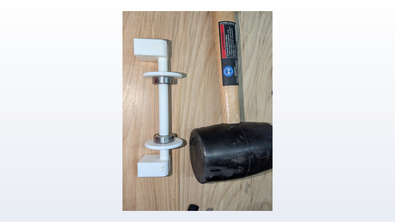 Assembled spool holder next to a mallet for scale